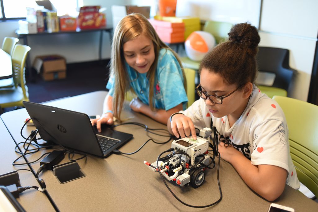 Destiny Sommer and Lydia Nystrom work with their robot