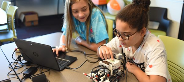 Destiny Sommer and Lydia Nystrom work with their robot