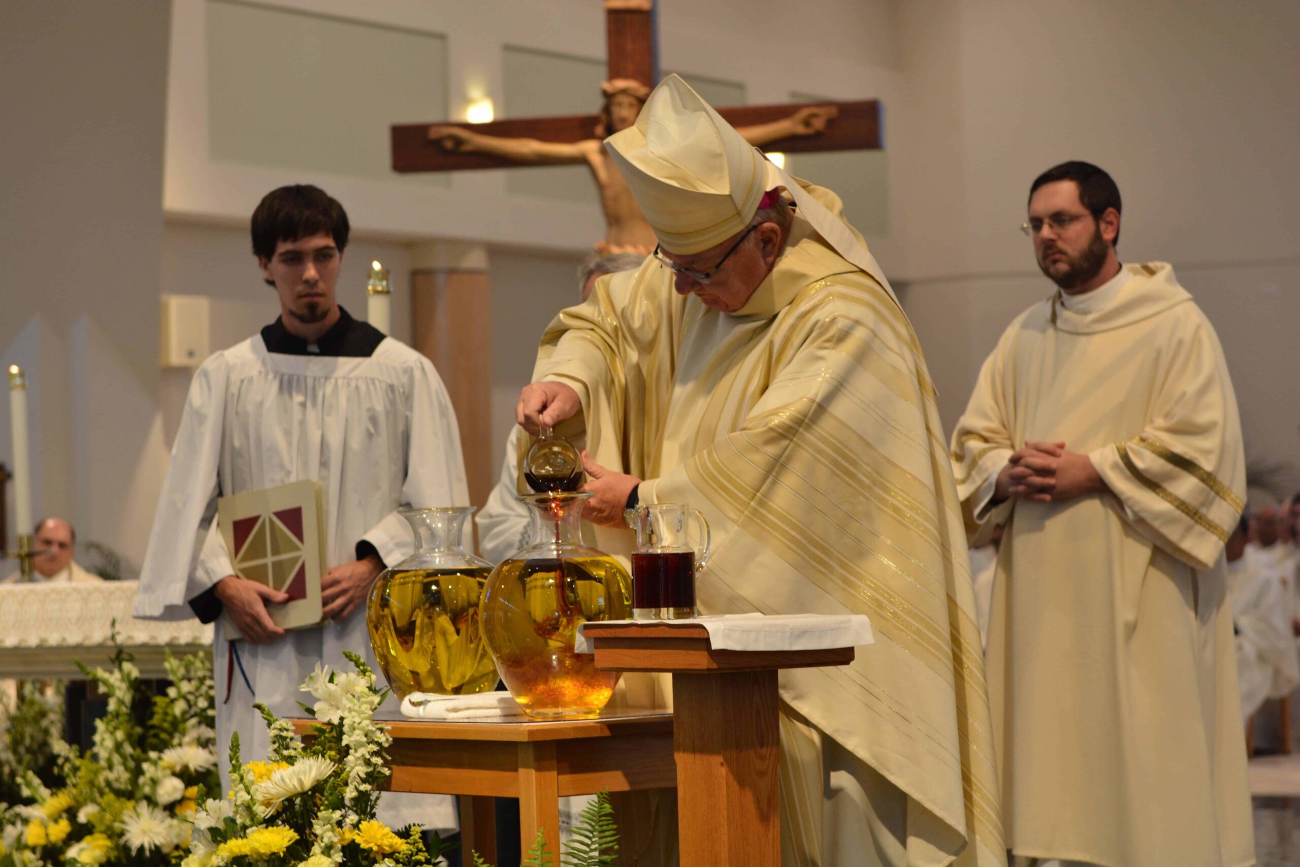 Bishop Lynch mixing olive oil and balsam before consecration. Photo credit: Maria Mertens