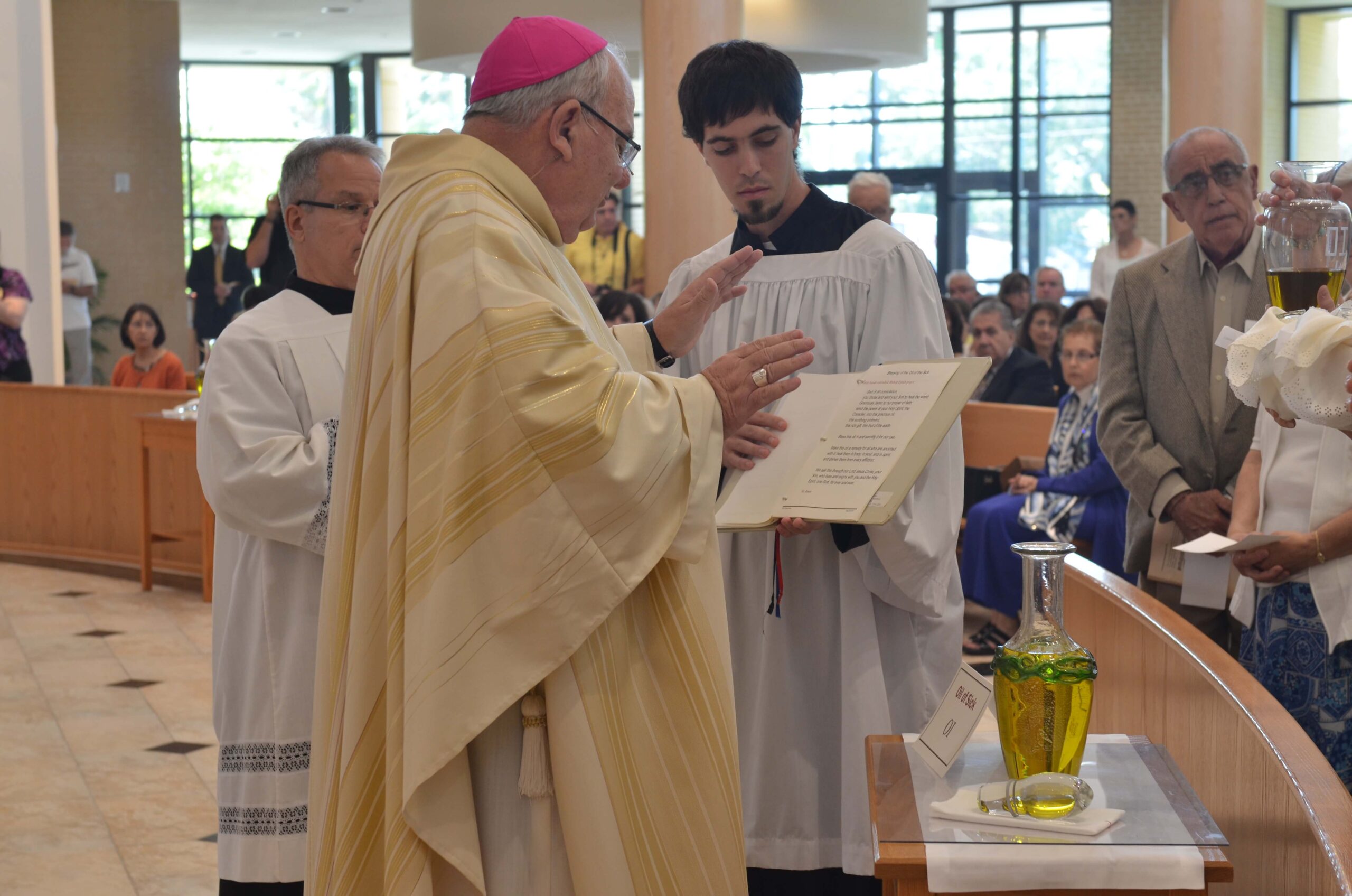 Bishop Lynch blessing the Oil of the Sick. Photo credit: Jeanne Smith.